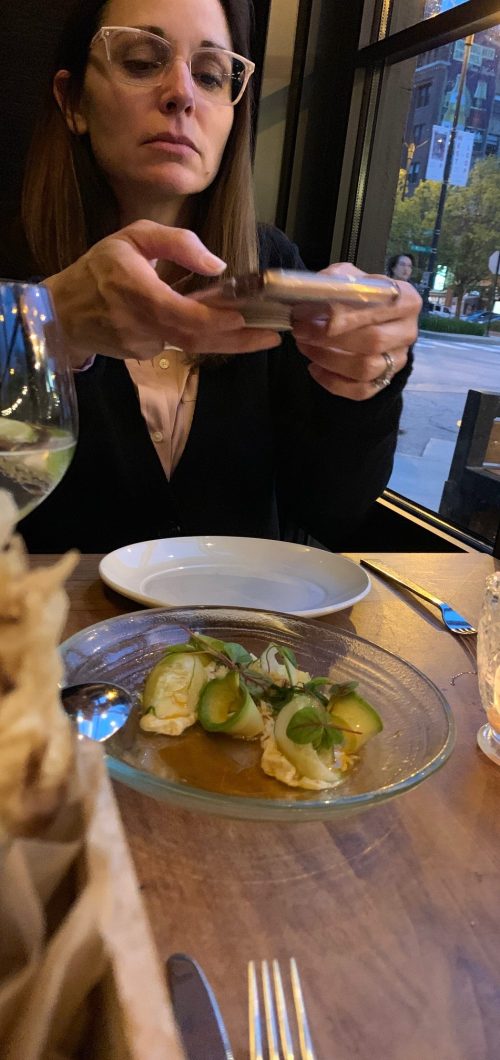 Melanie is taking a food pic for instagram